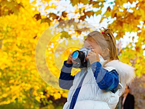 Little girl taking picture using vintage film camera