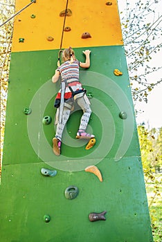 Little girl talking trains on climbing wall