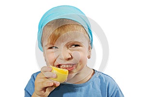 Little girl taste lemon