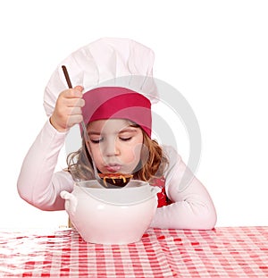 Little girl taste soup