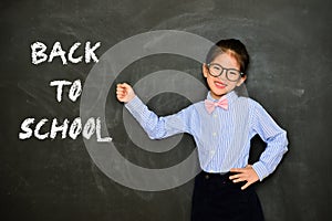 Little girl teacher showing back to school word