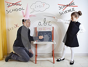 Little girl teaching mathematics to an adult dunce