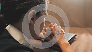 Little girl teenager praying in the night. Little girl hand praying. little girl holy bible prays with bible in her