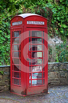 Little girl in a telephone booth