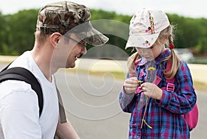 Little girl tells fortunes by daisy