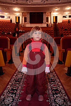 Little girl in theatrical hall