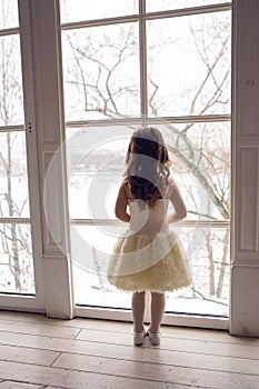 Little girl three years old in a white dress