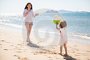 Little girl throwing beach ball