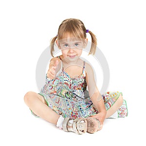 Little girl with thumb up on white background