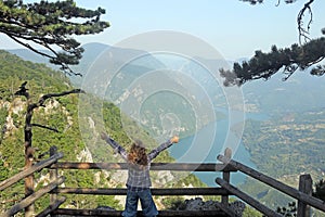 Little girl with thumbs up enjoy in nature viewpoint Banjska stena Tara photo