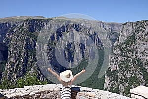 Little girl with thumbs up on the viewpoint Vikos gorge