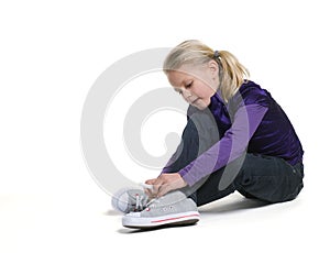 Little girl tie on her shoes