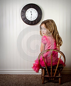 Little girl in time out or in trouble looking