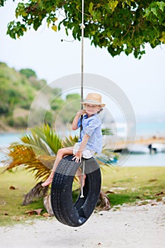 Little girl on tire swing