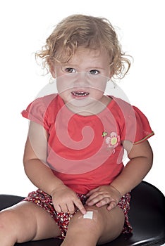 Little girl or toddler with a plaster on her leg