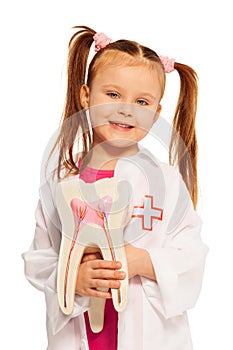 Little girl with tooth dummy playing dentist