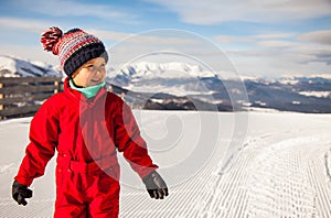 Little girl is on the top of Kokhta mount in Bakuriani, winter time