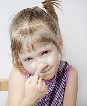 Little girl touching her nose