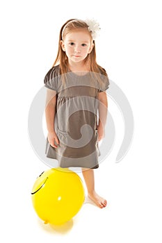Little girl with toy balloon looking