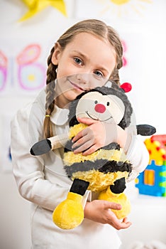 Little girl with toy bee
