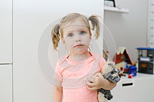 Little girl with toy in the children`s room