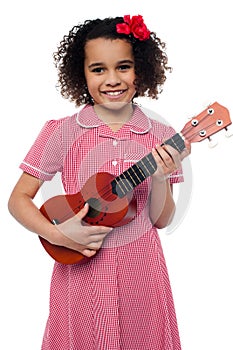 A little girl with a toy guitar