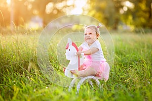 Little girl on a toy horse