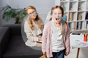 Little girl with toy screaming while