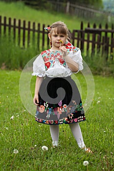 Little girl in traditional costume with flowers