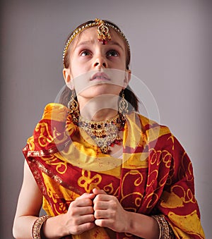 Little girl in traditional Indian sari and jeweler