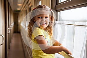 Little girl in the train, railway carriage photo