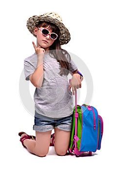 Little girl with travel bag with her finger up