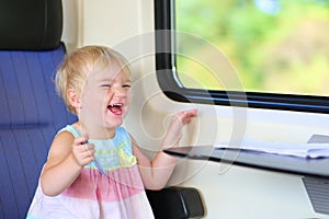 Little girl traveling by train