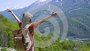 Little girl traveller admire the view. Hiking in mountains on summer. Child with backpack