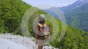 Little girl traveller admire the view. Hiking in mountains on summer. Child with backpack