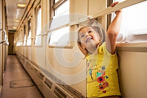 Little girl is travelling by train photo