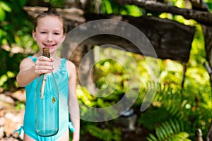 Little girl with treasure bottle