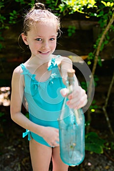 Little girl with treasure bottle