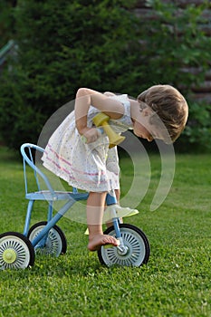 Little girl on the tricycle