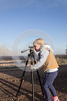 Little girl with a tripod