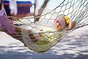Little girl on tropical vacation relaxing in
