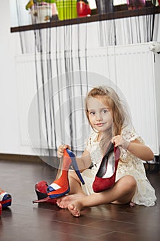 Little girl trying mother shoes