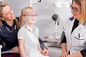 Little girl trying on optic glasses