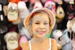 Little girl trying panama in store and smiling