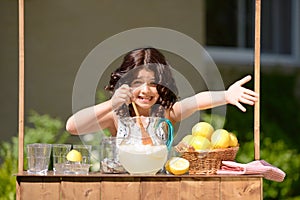 Little girl trying to sell lemonade