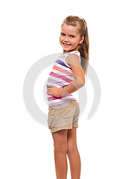 Little girl turned aside standing on white background