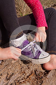 Little girl tying shoelaces