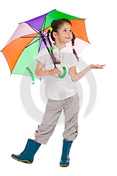 Little girl with umbrella, checking for rain