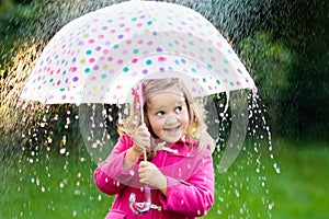 Little girl with umbrella in the rain