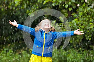 Little girl with umbrella in the rain